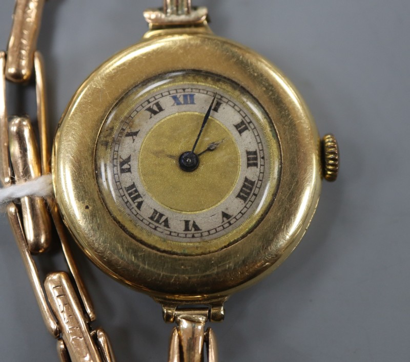 A ladys early 20th century 18ct gold manual wind wrist watch, on a 15ct flexible strap.